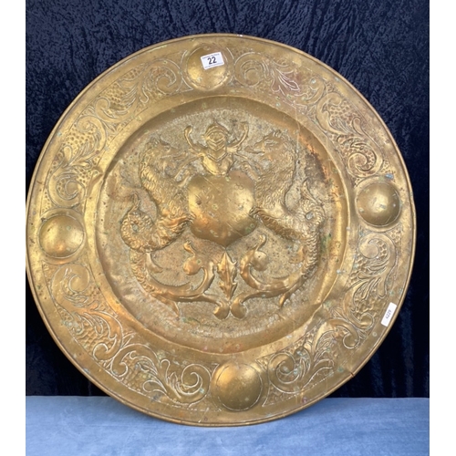 22 - Very large decorative brass alms dish with central crest design, approx 68cm diameter