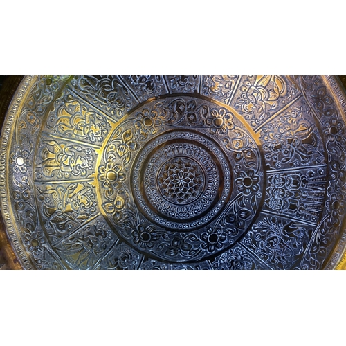 40 - Highly decorative convex brass dish with Oriental / Eastern figurines and floral design, approx 38.5... 