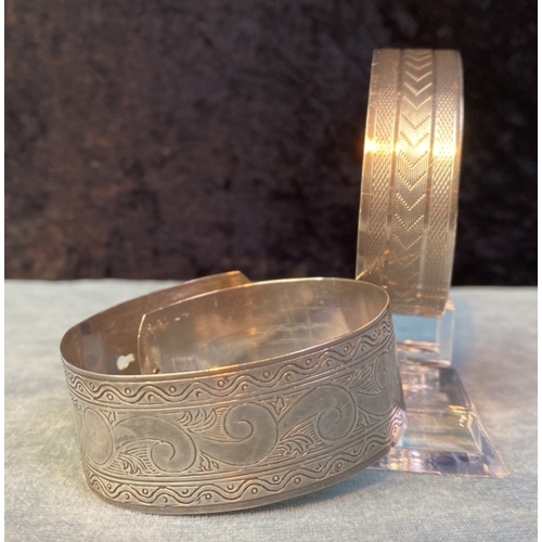 583 - Two pretty, wide bangles one marked Sterling Silver