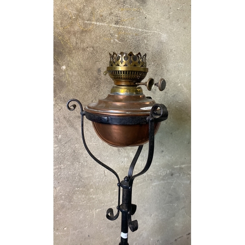 1 - Copper oil lamp on a cast iron stand, approx 142cm tall