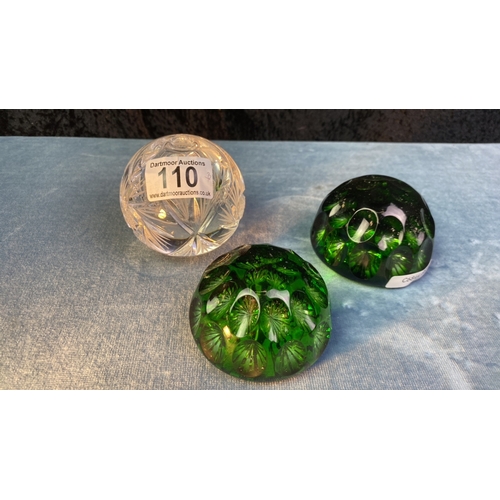 110 - Three very beautiful crystal glass paperweights inc 2 green starburst dimpled weights and one cut gl... 