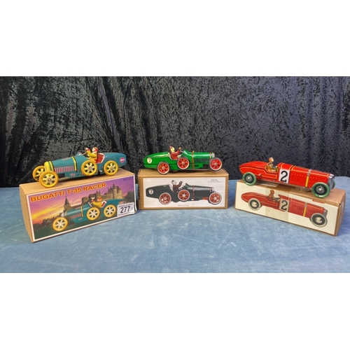 277 - Three boxed tinplate clockwork racing cars with keys in excellent condition