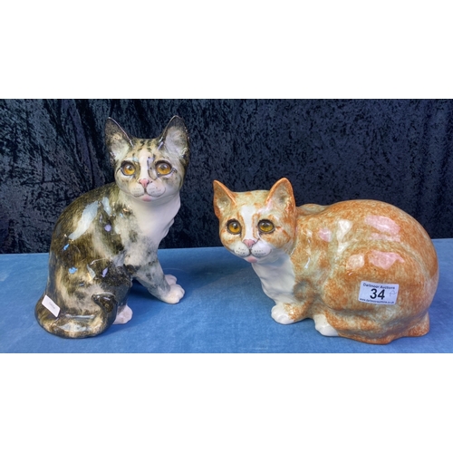 34 - Pair of Winstanley pottery cats with glass eyes, signed to bases