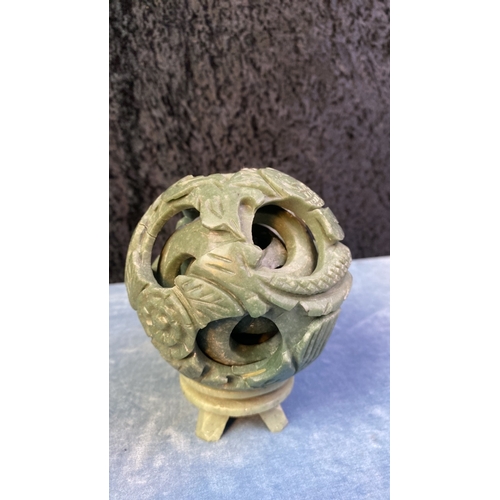 413 - Jade green intricately  magical puzzle ball on stand