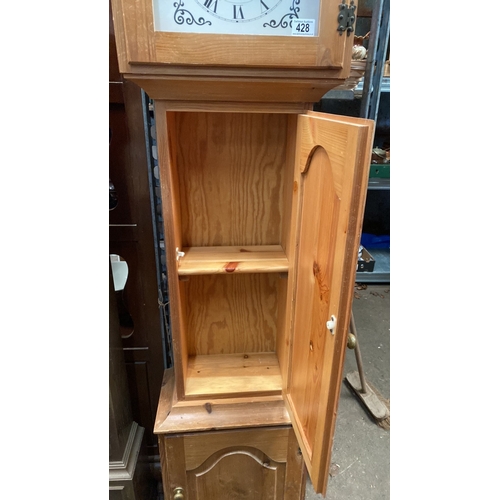 428 - A modern pine cased Grandfather clock with battery operated movement and useful storage space in the... 