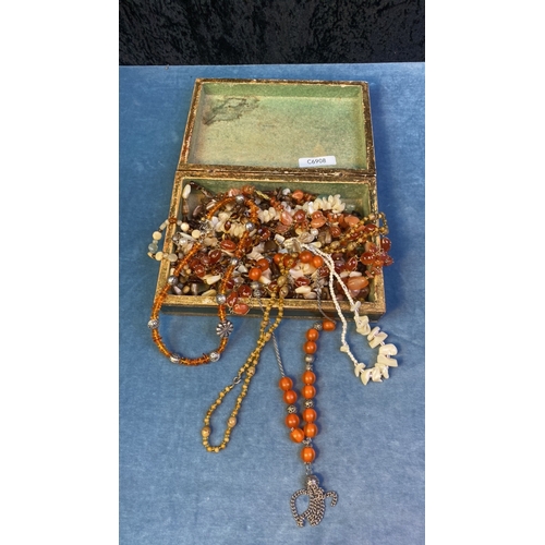 578 - Small jewellery casket with good collection of various brown bead necklaces