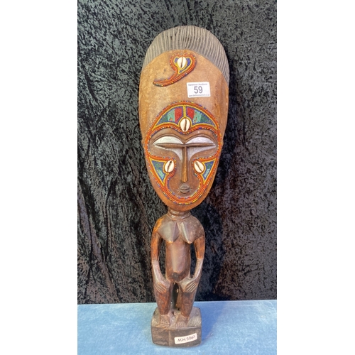 59 - Ethnic carved figure with shell and bead detail, approx 57cm tall