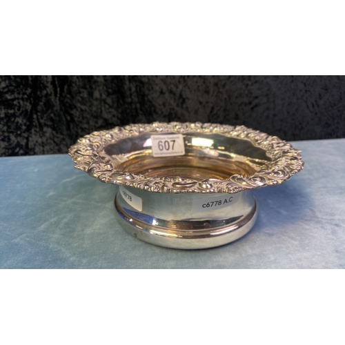 607 - White metal (possibly silver plate) champagne bottle coaster, approx 20cm diameter (at the rim)