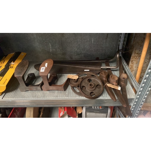 993 - A pair of cobblers cast iron shoe lasts, three pick axe heads, a trio of assorted cast wheels, and t... 