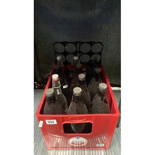 994 - A crate of assorted vintage brown and clear glass 2 pint screw top bottles