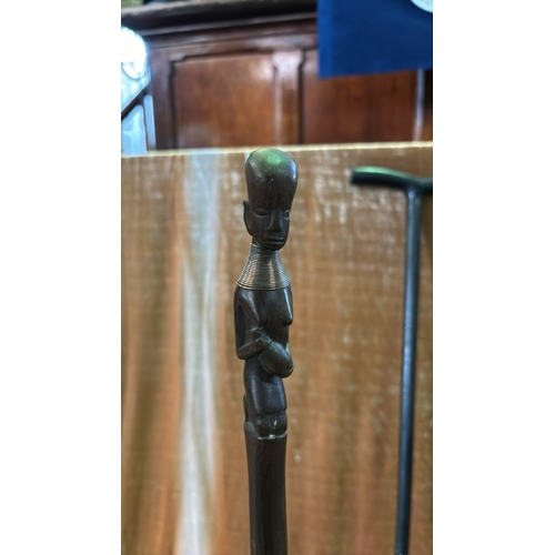 41 - Two beautifully carved walking sticks, one with ethnic African figure