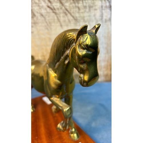47 - Brass horse figurine on a wooden plinth, approx. 22 cm tall