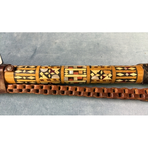 53 - Egyptian camel whip with fine inlaid wood and mother of Pearl design to shaft and a plaited leather ... 