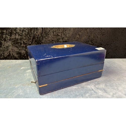 68 - Blue painted wooden writing slope box with original ink well and matchbox with striker and brass det... 