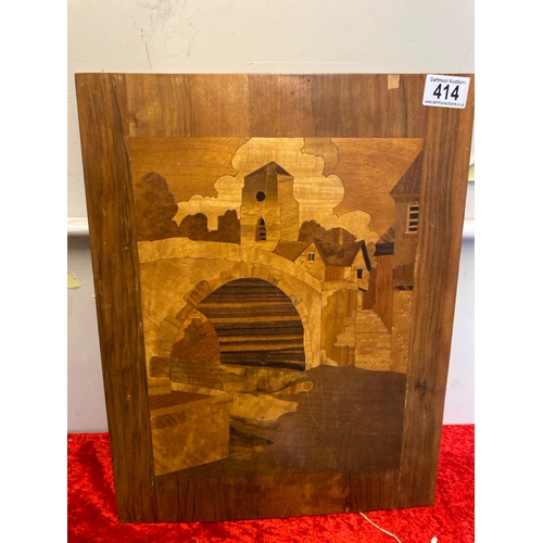 414 - Wooden marquetry scene of a town with river / canal, approx 44.5cm x 34.5cm (chip to top of board)