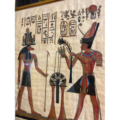 445 - Framed signed Egyptian papyrus painting of Chnum and Ramses II, frame approx 41cm x 33cm