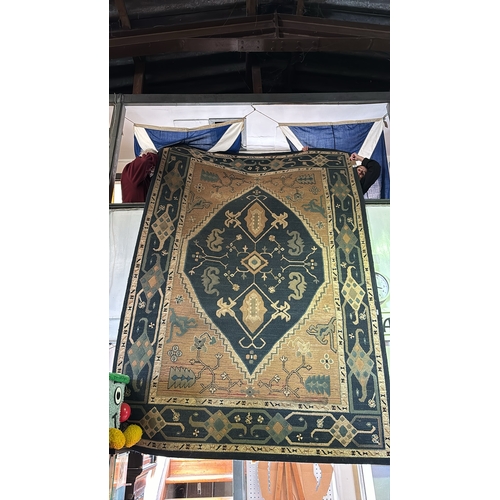 459 - Large floor rug with blue and brown design, measures approx 288cm x 198cm