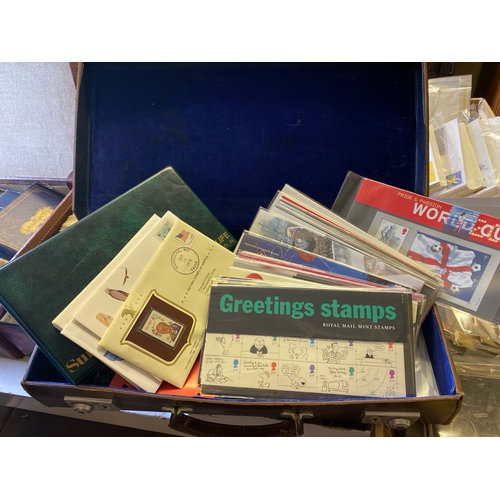 497 - A lovely, small attaché case crammed full of over 30  commemorative stamp packs, 1st day covers and ... 