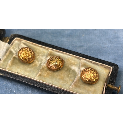 592 - Cased set of yellow metal shirt studs