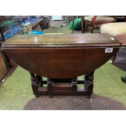 688 - Oak drop leaf occasional table.  H48CM x W70cm x D25cm.  Circular when extended.