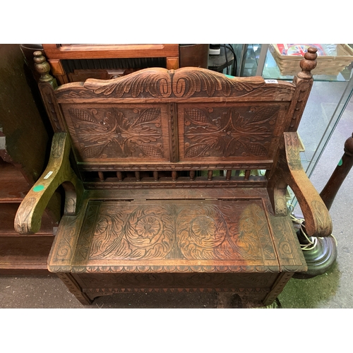 690 - Heavily detailed carved oak hallway bench with storage under seat.  H97cm x W87cm x D45cm.