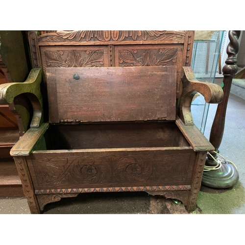 690 - Heavily detailed carved oak hallway bench with storage under seat.  H97cm x W87cm x D45cm.