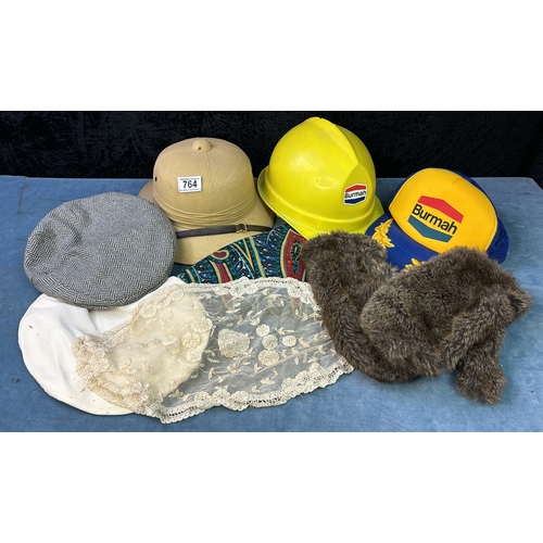 764 - An assortment of hats including Burmah cap and hard hat, and wonderful faux fur mittens