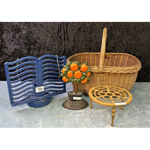 789 - 2 items of heavy cast, a doorstop and a menu holder, along with a vintage wicker basket and a brass ... 