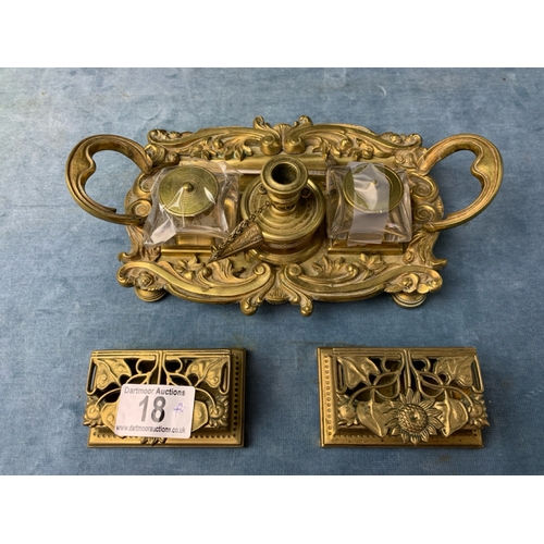 18 - Brass desk set with two glass inkwells, a brass sword letter opener and two brass stamp holders
