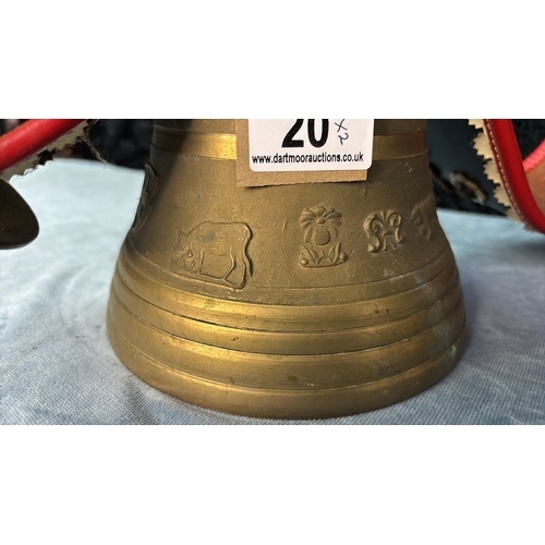 20 - Two very large brass cowbells on leather straps with embellishments depicting an Edelweiss flower an... 