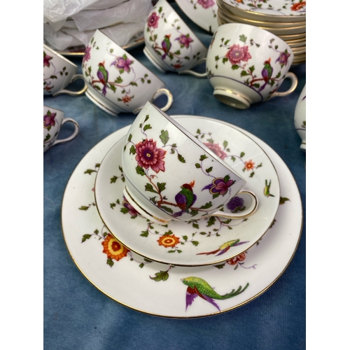 296 - A pretty set of Crown Staffordshire decorated with birds of paradise, flowers, with a purple liner a... 