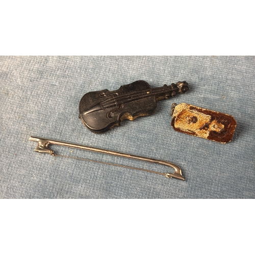 677 - Miniature wooden violin with silver bow and clasp.