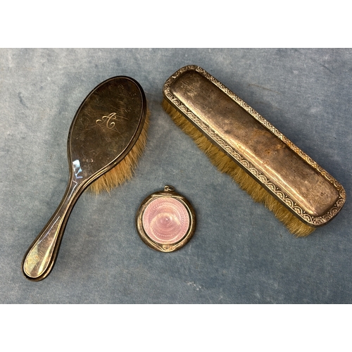 692 - 2  silver backed hair brushes and an Art Deco silver compact (dented) with exquisite  mauve Guilloch... 