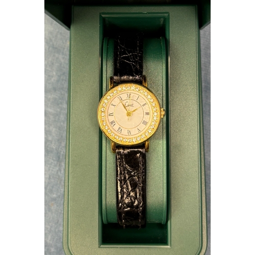 704 - Pretty decorative ladies quartz watch with black leather strap. By Limit.