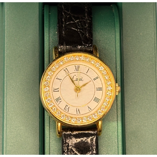 704 - Pretty decorative ladies quartz watch with black leather strap. By Limit.