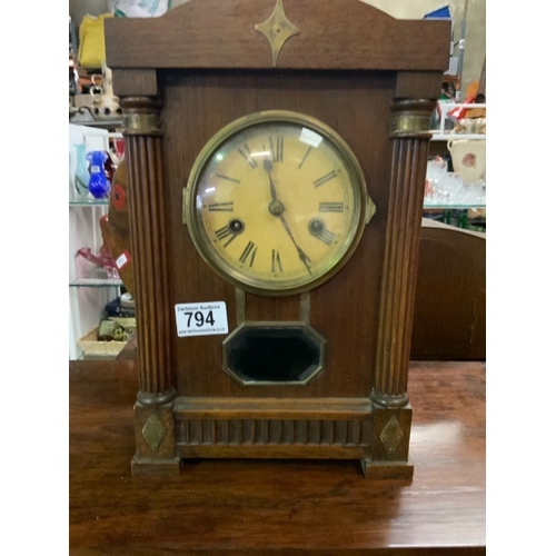 794 - Elegant mantle clock with colonnade surround and brass detail and bevelled glass view port H34cm x 2... 