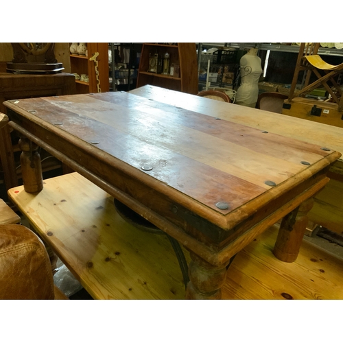 801 - Very solid wooden coffee table with stout legs and metal banding W60xL110 approx