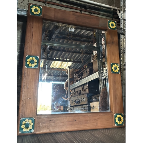 81 - Bevel edges mirror with wooden frame and flower design panels, measures approx 79cm x 68cm