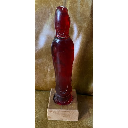 435 - Chinese cherry amber coloured figure of Guanyin (damage to hand)