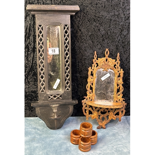 18 - Two mirrored carved wooden wall sconces, one with candle holder and four turned wooden napkin rings