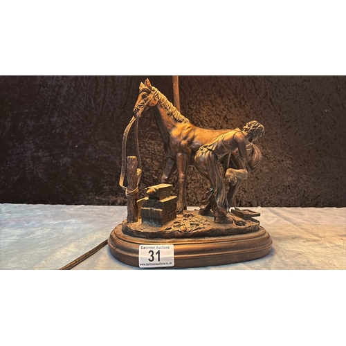 31 - Widdop, Bingham & Co. resin lamp depicting a farrier shoeing a horse (a/f damage to figure’s arm)