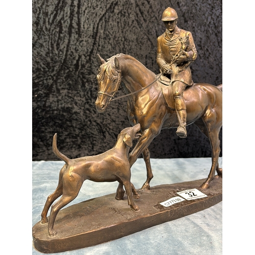 32 - Cold cast bronze sculpture depicting a hunter with hound by David Geenty (one rein needs reattaching... 