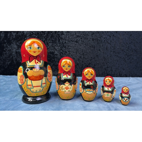 69 - Two wooden Russian Doll sets, tallest dolls are approx 20cm and 16cm tall