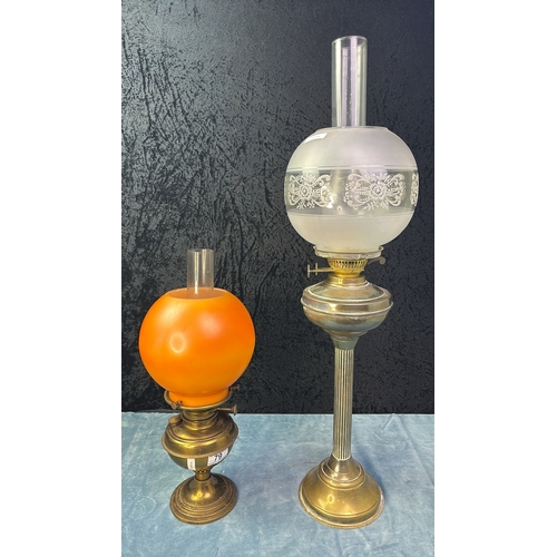 79 - Two brass oil lamps with glass shades and funnels, approx 74cm and 47cm tall (including funnel)