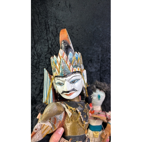 110 - Two Wayang Golek Indonesian stick puppets, two Pelham puppets of a girl and a witch, a painted woode... 