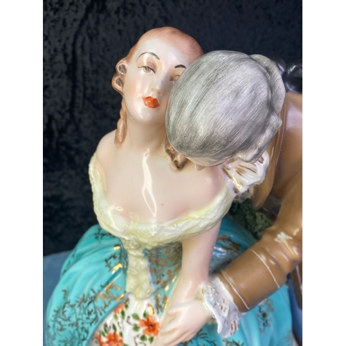 164 - Large Italian figurine of a couple in period dress on a wooden base. Approx 42cm tall.