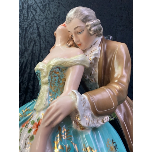 164 - Large Italian figurine of a couple in period dress on a wooden base. Approx 42cm tall.