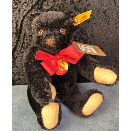 401e - Steiff Bobby musical teddy bear with guitar, black mohair fur, winds up at the back and plays a tune... 