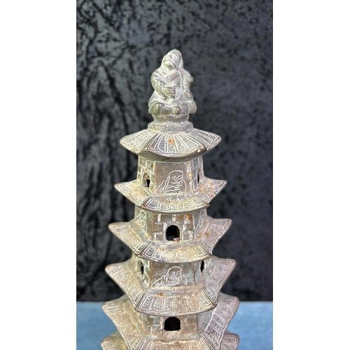 404 - Chinese heavy metal / bronze pagoda on intricately carved and footed  wood stand Pagoda H 27cm