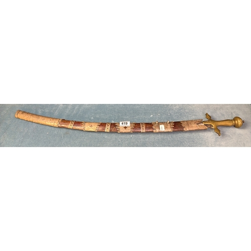 419 - Highly decorative curve bladed Eastern sword, with intricate engraving to blade in a decorative wood... 